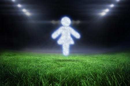 Cloud in shape of woman against football pitch with bright lightsの写真素材