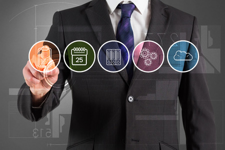 Composite image of businessman in suit pointing finger at menu against grey vignetteの写真素材