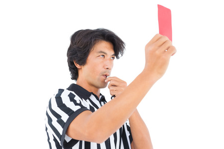 Stern referee showing red card on white backgroundの写真素材
