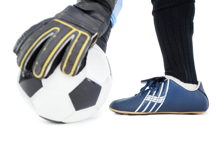 Goalkeeper picking up the ball on white backgroundの写真素材