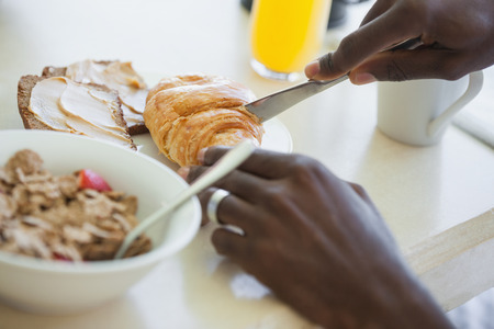 Man having breakfast on terrace on a sunny dayの写真素材