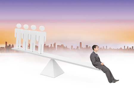 Scales weighing businessman and stick men against cityscape and purple skyの写真素材