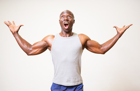 Portrait of a muscular man shouting over white backgroundの写真素材