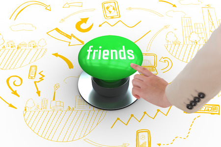 The word friends and businesswoman pointing against digitally generated green push buttonの写真素材