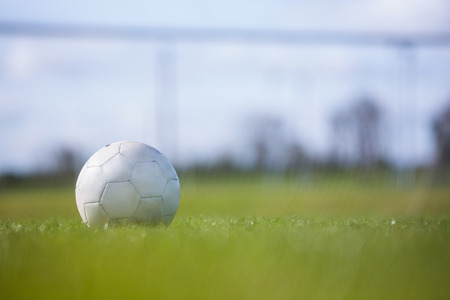 Football on an empty pitch on a clear dayの写真素材