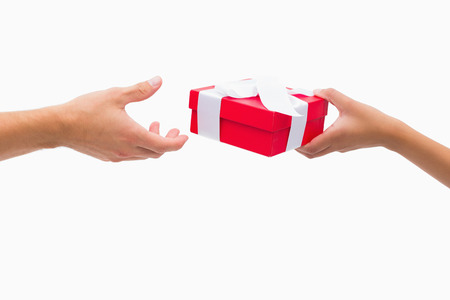 Woman passing man a gift on white backgroundの写真素材