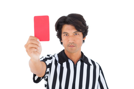 Stern referee showing red card on white backgroundの写真素材