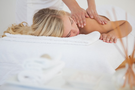 Pretty blonde enjoying a massage at the health spaの写真素材