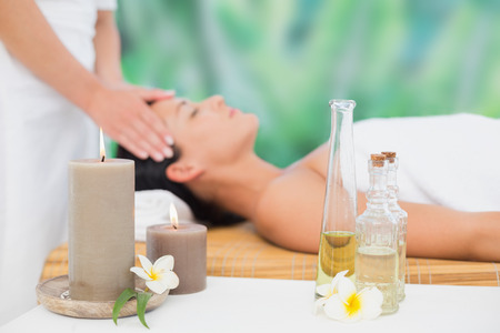 Beautiful brunette enjoying a head massage at a luxury spaの写真素材