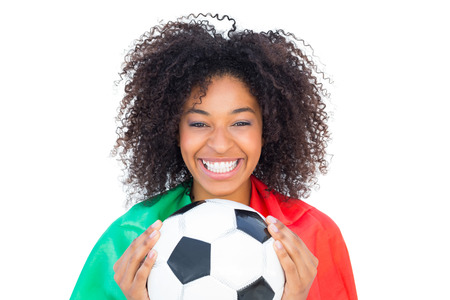 Pretty football fan with portugal flag holding ball on white backgroundの写真素材