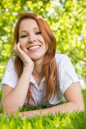 Pretty redhead relaxing in the park on a sunny dayの写真素材