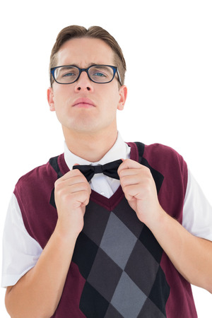 Nerdy hipster fixing his bow tie on white backgroundの写真素材