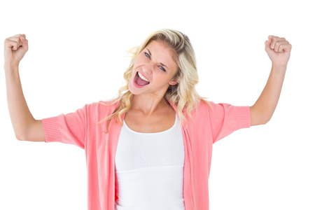 Pretty young blonde feeling successful on white backgroundの写真素材