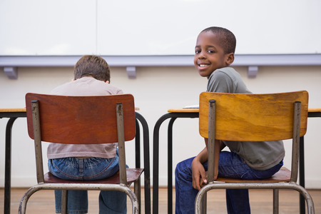 Cute pupils listening attentively in classroom at the elementary schoolの写真素材