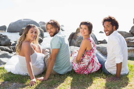 Gorgeous friends smiling at camera on a sunny dayの写真素材