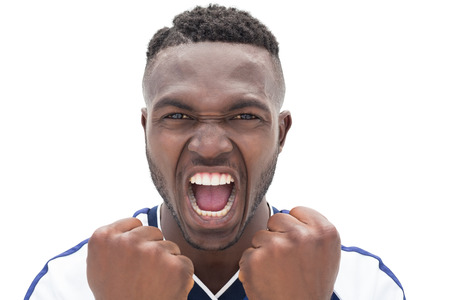 Close up of a football player shouting over white backgroundの写真素材