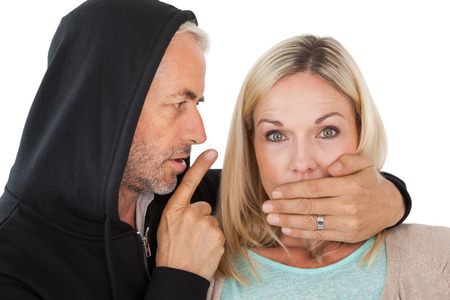 Close up of theft covering woman's mouth over white background