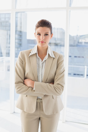 Pretty businesswoman looking at camera in her officeの写真素材
