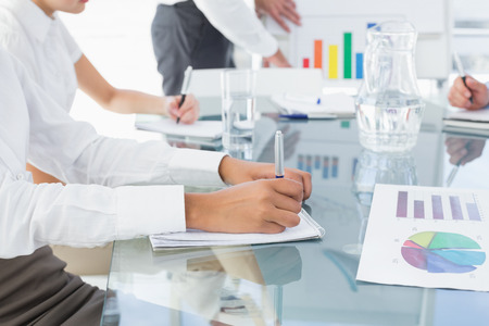 Business woman writing down notes at a meetingの写真素材