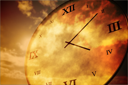 Digitally generated roman numeral clock on orange skyの写真素材
