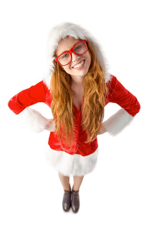 Festive redhead smiling at camera on white backgroundの写真素材