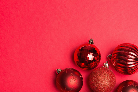 Shiny red group of christmas baubles  on red background