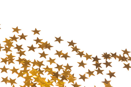 Golden star decorations spread out on white background