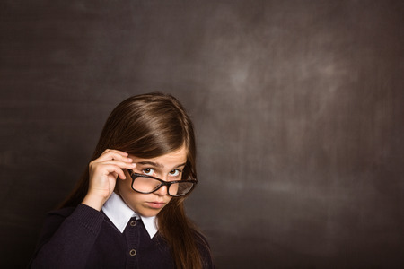 Cute pupil smiling at camera on black backgroundの写真素材