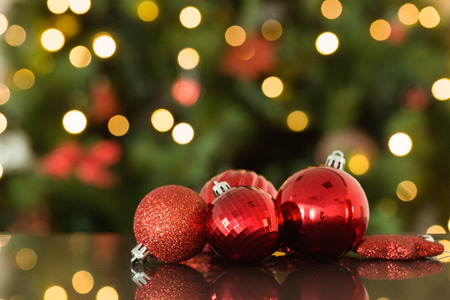 Focus on red christmas baubles at home in the living room