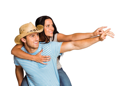 Man giving his pretty girlfriend a piggy back on white backgroundの写真素材