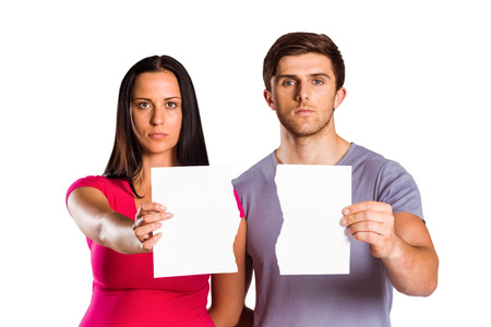 Couple showing broken piece of paper on white backgroundの写真素材