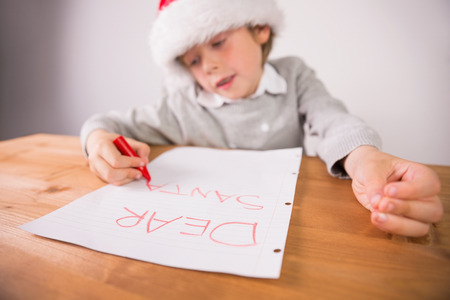 Child writing letter to santa at the deskの写真素材