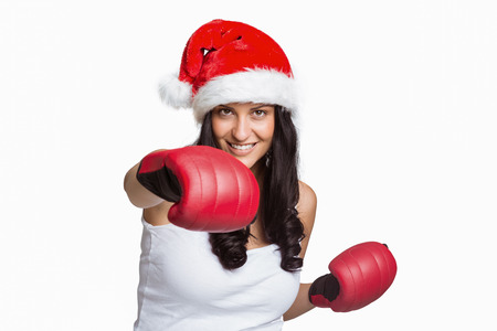 Woman wearing red boxing gloves on white backgroundの写真素材