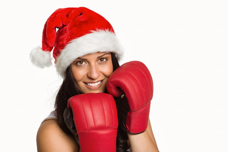 Woman wearing red boxing gloves on white backgroundの写真素材