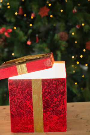 Light shining from christmas present at home in the living roomの写真素材