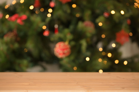 Desk with christmas tree in background at home in the living room