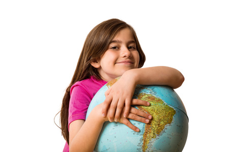 Cute pupil smiling holding globe on white backgroundの写真素材