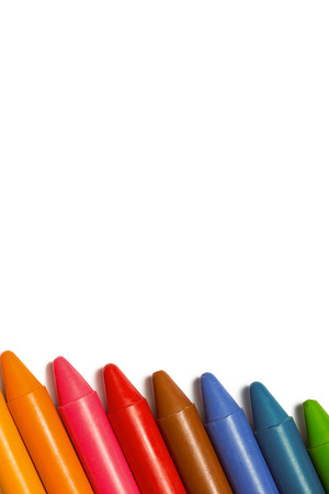 Colourful crayons in a row on white backgroundの写真素材