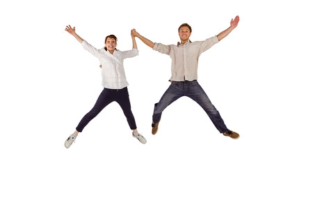 Couple jumping and holding hands on white background