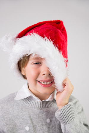 Child wearing a santa hat on white backgroundの写真素材