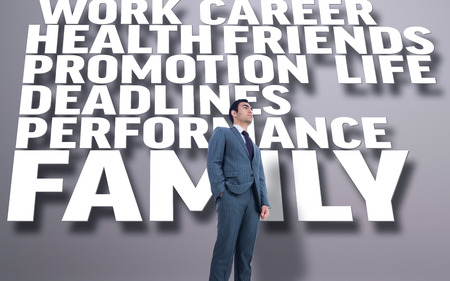 Unsmiling businessman standing against grey background with textの写真素材