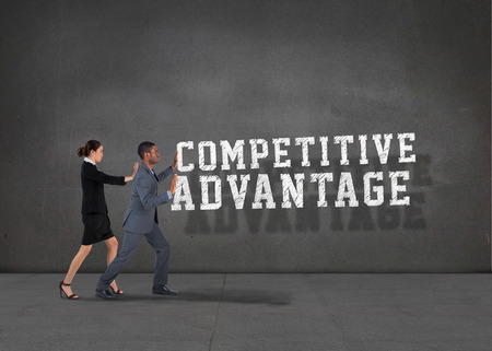 Composite image of business team standing and pushing against buzz words in roomの写真素材