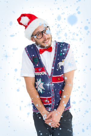 Geeky hipster in santa hat against snow fallingの写真素材