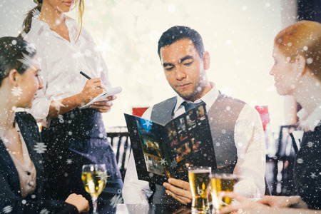 Handsome businessman ordering dinner from waitress against snow