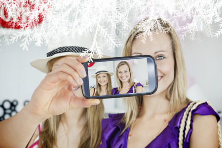 Hand holding smartphone showing photo showing against frostの写真素材