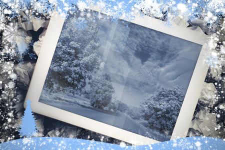 Composite image of tablet screen against snow flake frame in blueの写真素材