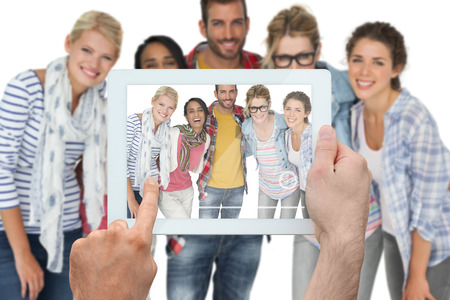 Composite image of hand holding tablet pc showing photograph