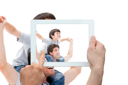 Composite image of hand holding tablet pc showing photograph