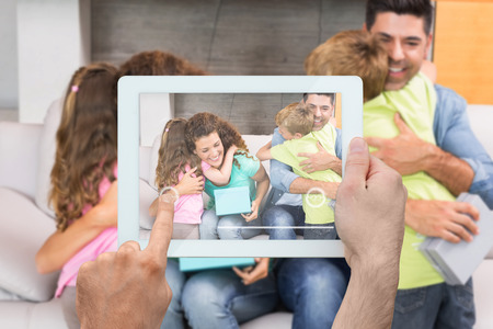 Composite image of hand holding tablet pc showing photograph