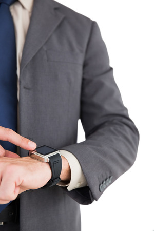 Businessman using his smart watch on white backgroundの写真素材